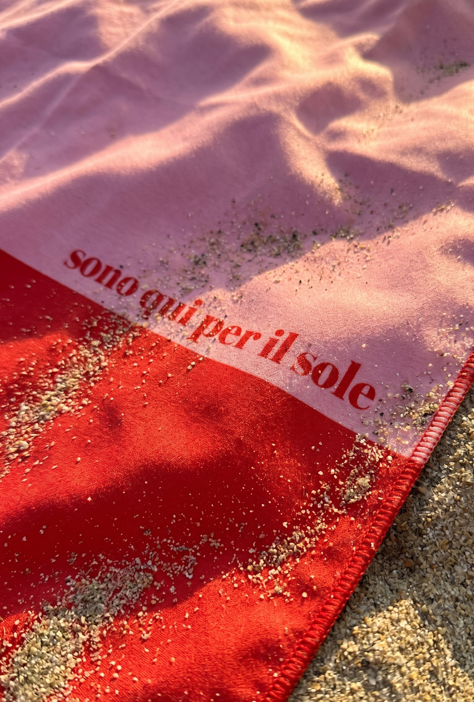 Salerno rPET microfibre travel towel closeup at beach, sustainable travel towel made from recycled plastic bottles