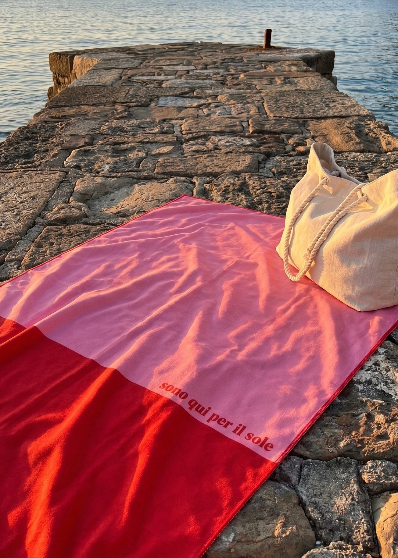 Salerno pink and red microfibre travel towel at mediterranean pier with beach bag, quick-dry travel towel